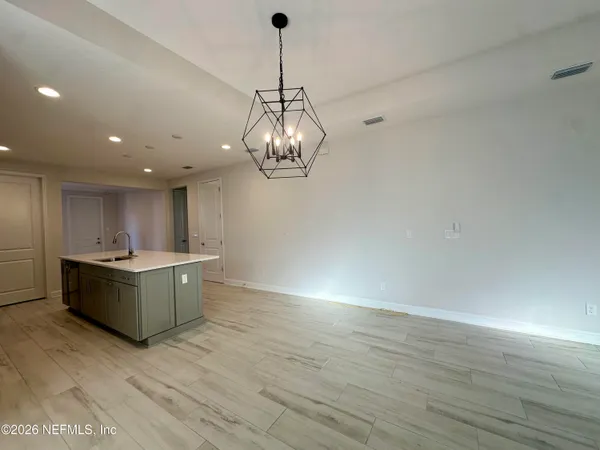 a kitchen with a sink cabinets and wooden floor