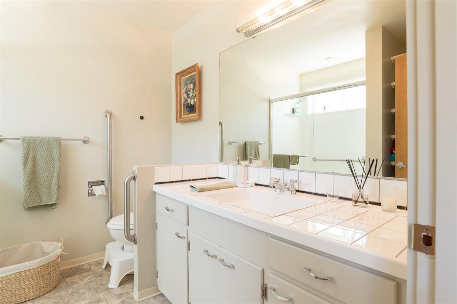 206 West Hilltop Road Talent, OR 97540 - Photo 21 of 29 a en suite bathroom with a granite countertop sink and a mirror