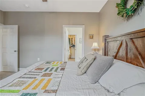 a bedroom with a bed and a potted plant
