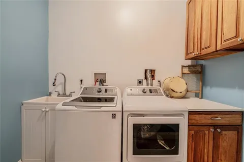a kitchen with a stove top oven and cabinets