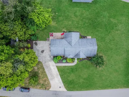an aerial view of a house with garden space and street view