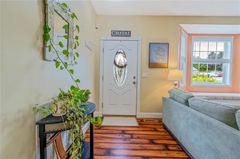a living room filled with furniture and a potted plant