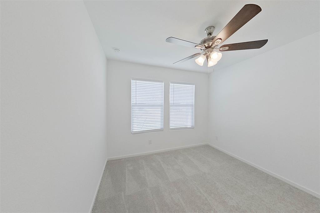 814 Ginkgo Way Princeton, TX 75407 - Photo 12 of 24 an empty room with a window and a fan