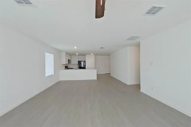 a view of a kitchen with a sink and a window