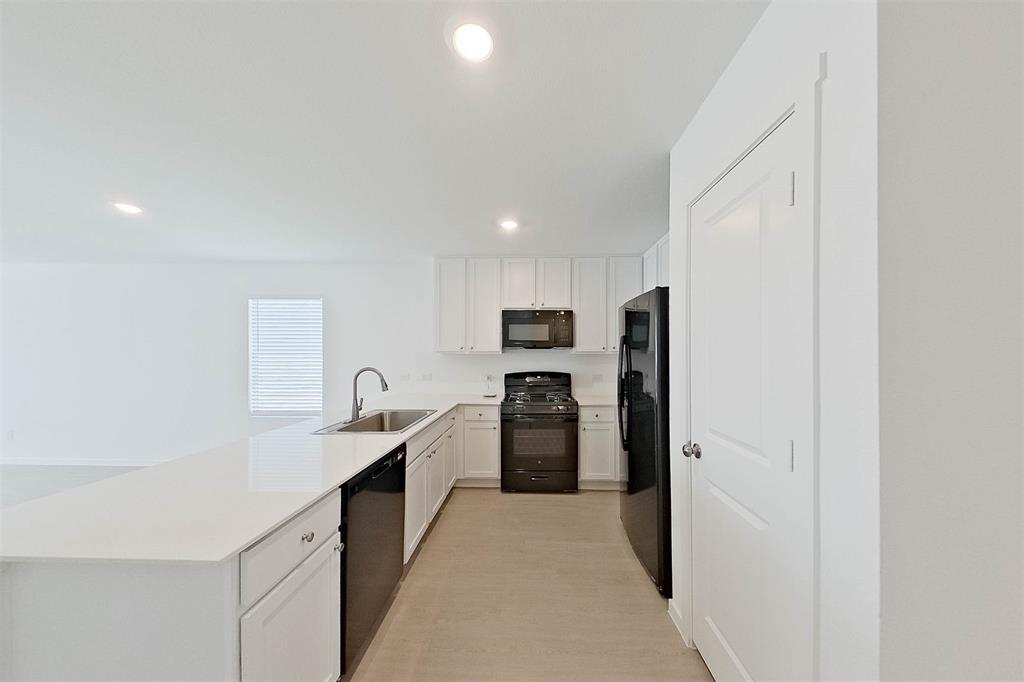 814 Ginkgo Way Princeton, TX 75407 - Photo 5 of 24 a kitchen with stainless steel appliances granite countertop a refrigerator and a sink