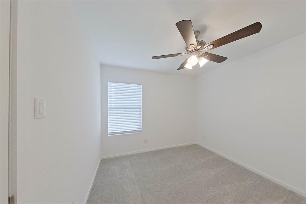 814 Ginkgo Way Princeton, TX 75407 - Photo 10 of 24 an empty room with a window and a fan