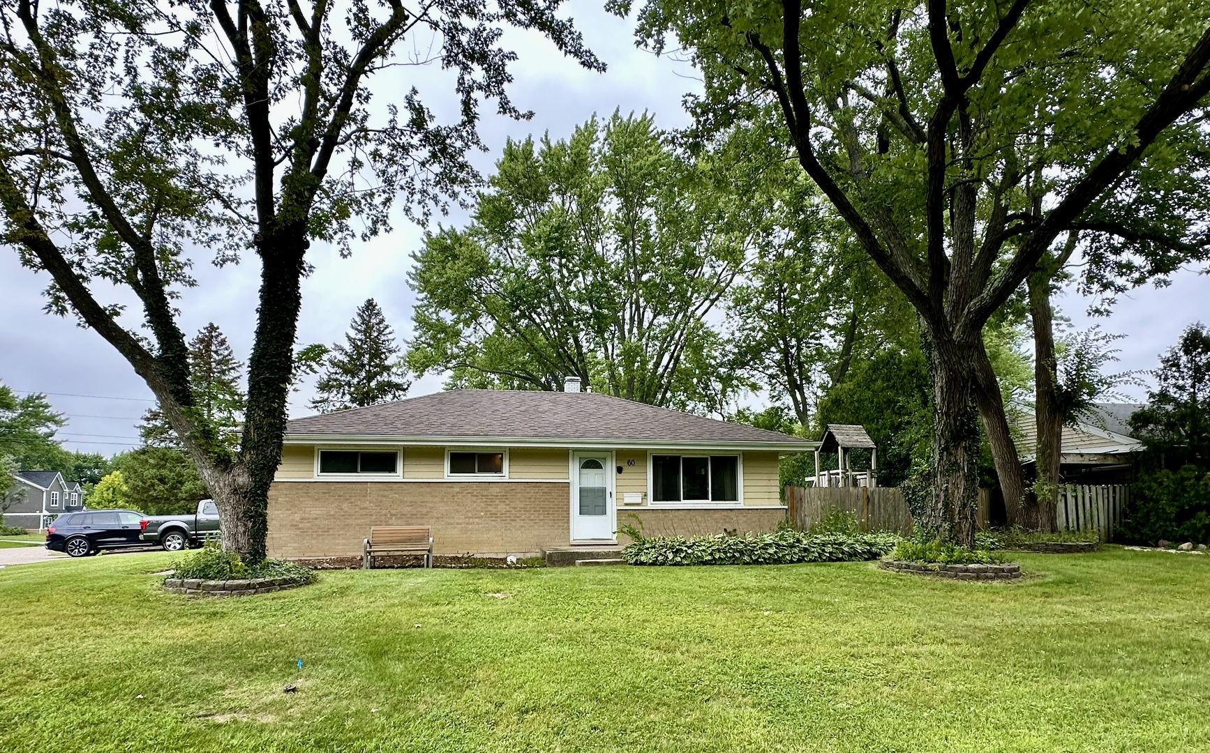 a front view of a house with a garden