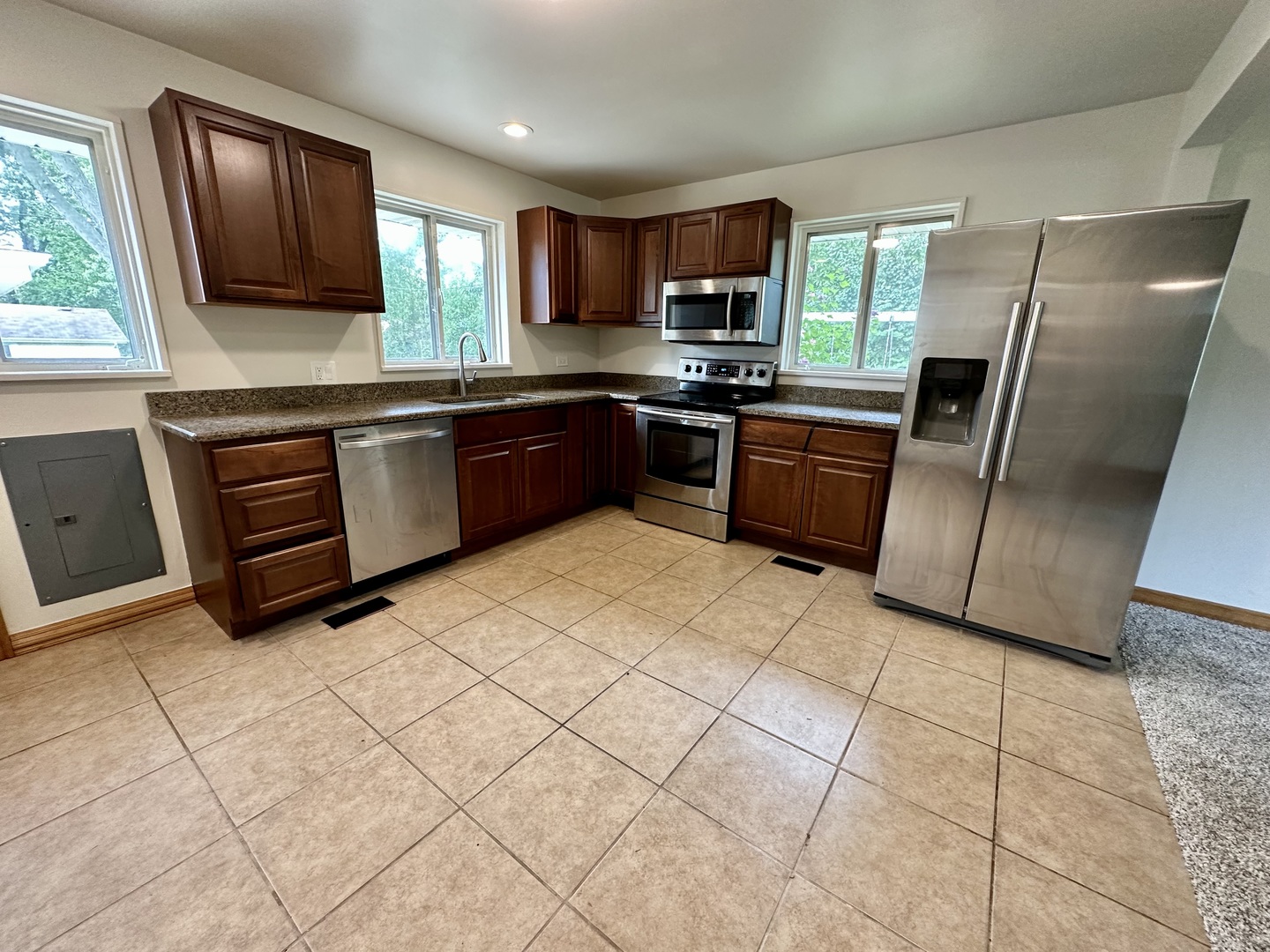 60 Golfview Road Lake Zurich, IL 60047 - Photo 5 of 10 a kitchen with stainless steel appliances granite countertop a refrigerator sink and stove