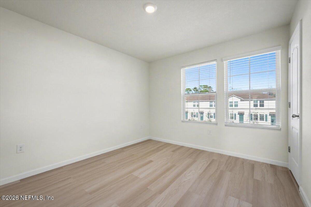 8212 Larose Road Jacksonville, FL 32211 - Photo 18 of 32 an empty room with wooden floor and windows