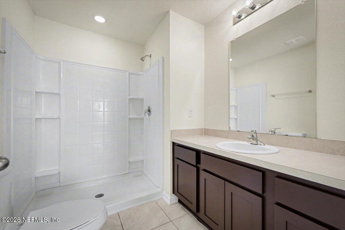 8212 Larose Road Jacksonville, FL 32211 - Photo 6 of 32 a bathroom with a granite countertop sink mirror and shower