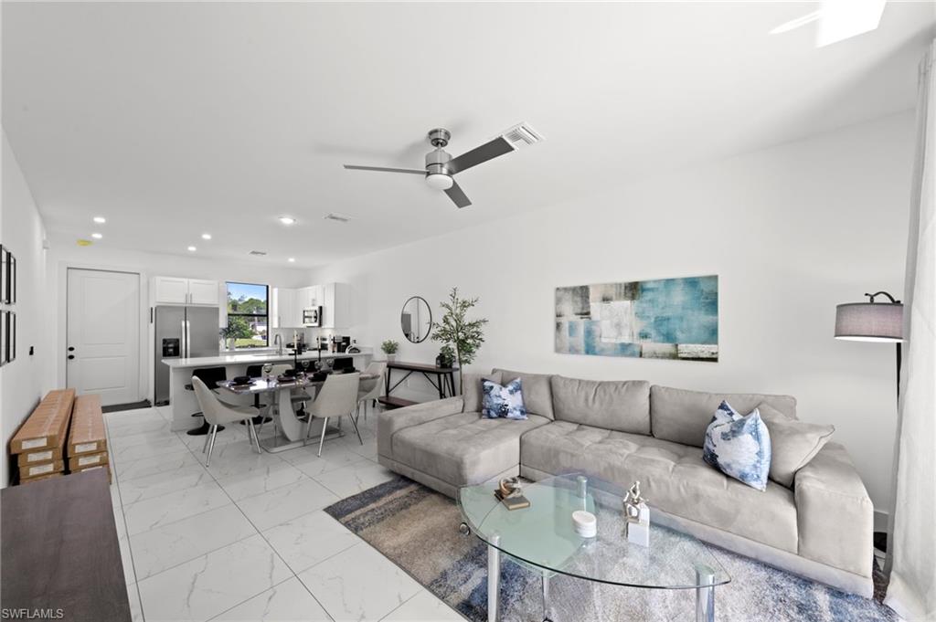 907 Homestead Road South Lehigh Acres, FL 33974 - Photo 5 of 29 a living room with furniture kitchen view and a window