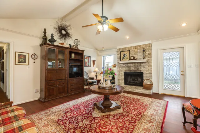 a living room with furniture a flat screen tv and a fireplace