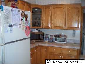 209 Clipper Road Manahawkin, NJ 08050 - Photo 3 of 3 a kitchen with stainless steel appliances granite countertop a sink and a refrigerator