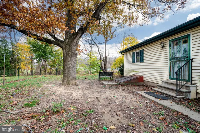 a view of a house with a yard and tree