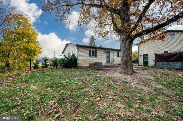 a tree in front of a white house