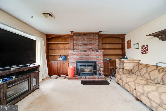 a view of a livingroom with furniture and a flat screen tv