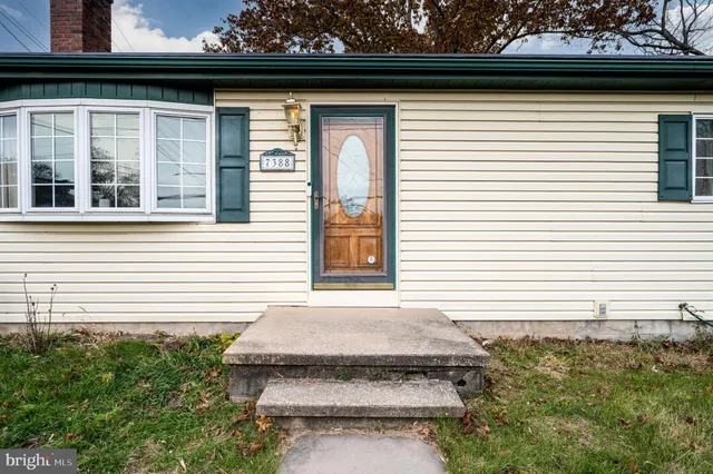 a side view of a house with a yard
