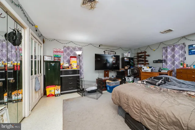 a bedroom with bed and a window