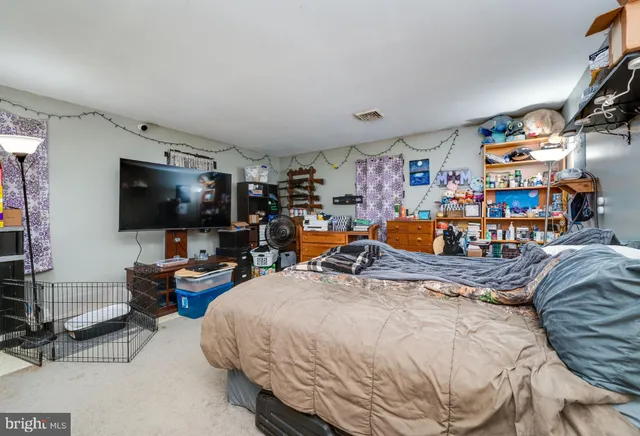 a bedroom with a bed and a book shelf