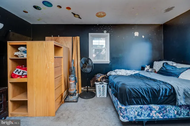 a living room with furniture a flat screen tv and a floor to ceiling window