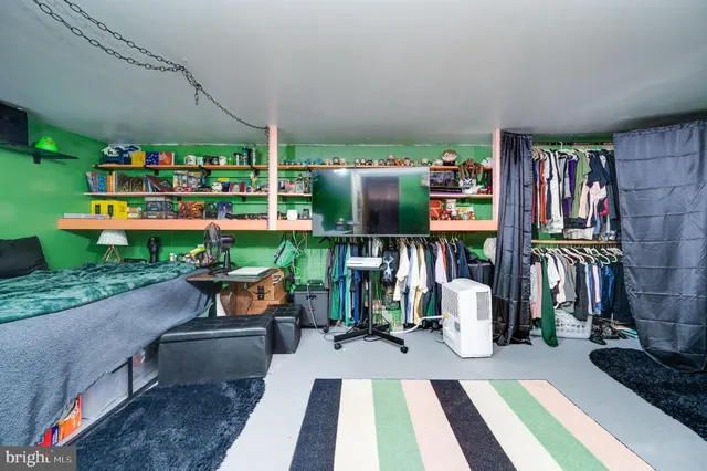 a view of a closet with wooden floor
