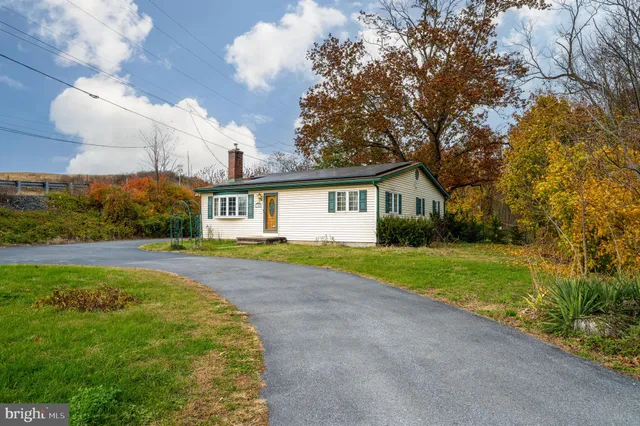 a view of a house with yard and a garden