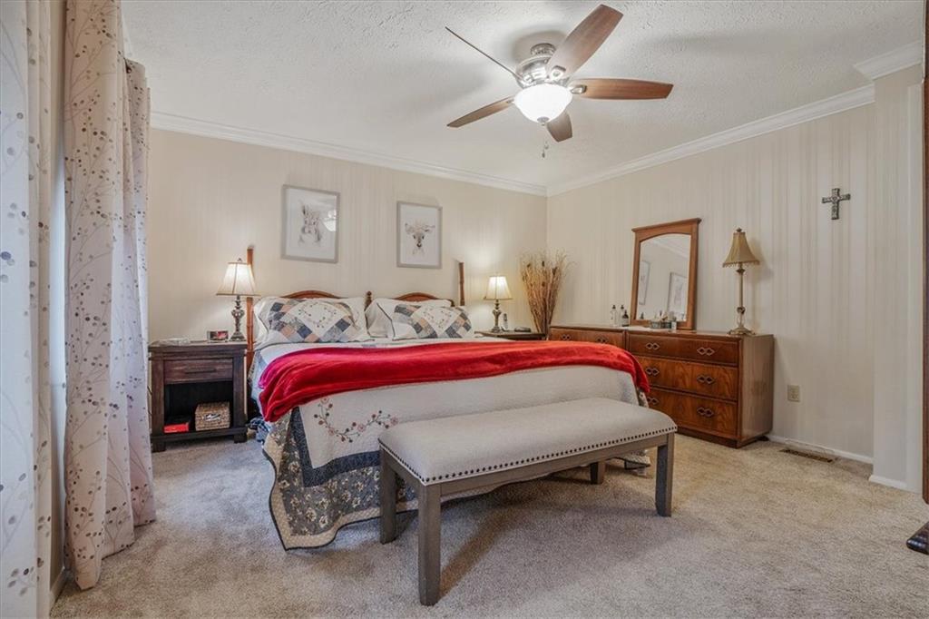 203 Green Court Pittsburgh, PA 15234 - Photo 16 of 38 a spacious bedroom with a bed and a chandelier
