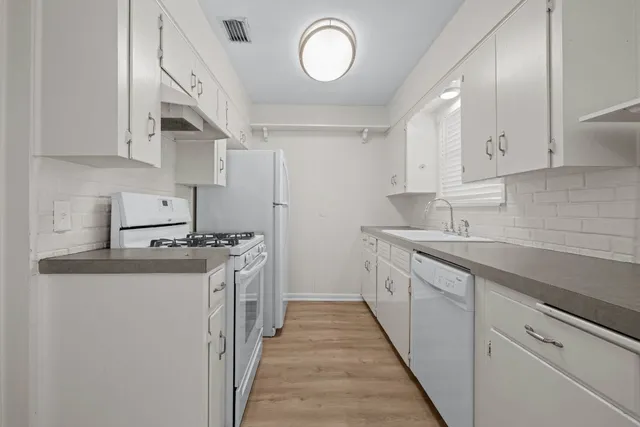 a kitchen with a sink cabinets and a window