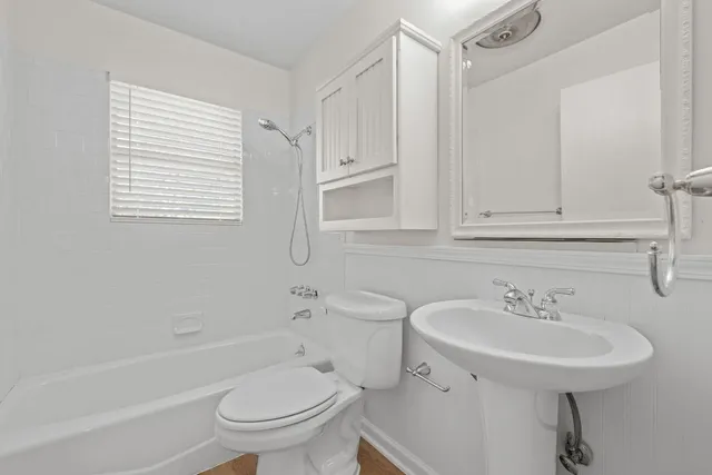 a bathroom with a bath tub with a shower