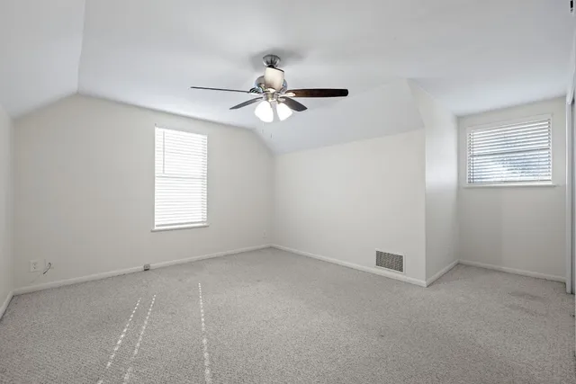 a bathroom with a granite countertop sink a toilet and a mirror