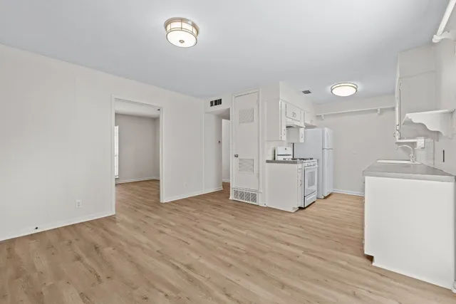 a view of a kitchen with wooden floor