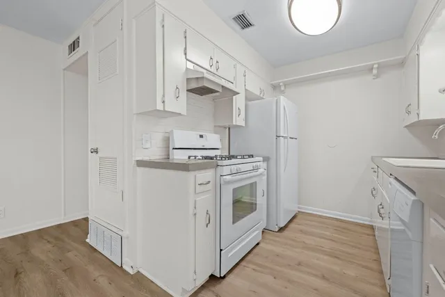 a kitchen with stainless steel appliances granite countertop a stove and a sink