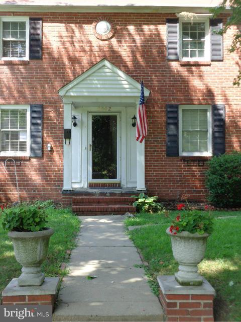3002 Dunbrin Road Baltimore, MD 21222 - Photo 27 of 30 a front view of a house with a yard and potted plants