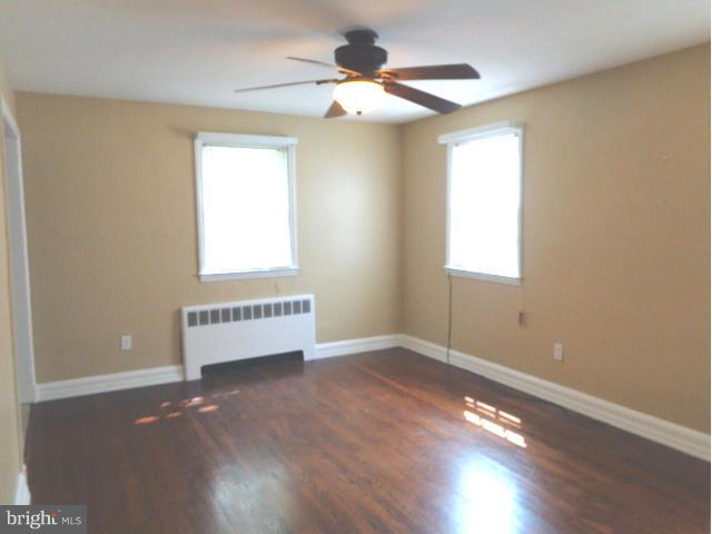 3002 Dunbrin Road Baltimore, MD 21222 - Photo 5 of 30 a view of an empty room with wooden floor and a window