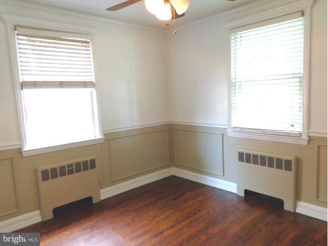 3002 Dunbrin Road Baltimore, MD 21222 - Photo 6 of 30 a view of an empty room with wooden floor and a window