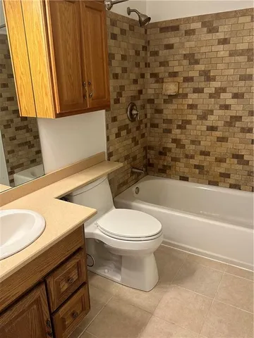 a bathroom with a sink a toilet and bathtub