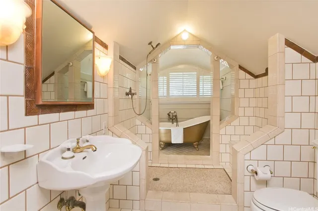 a bathroom with a sink a toilet and mirror
