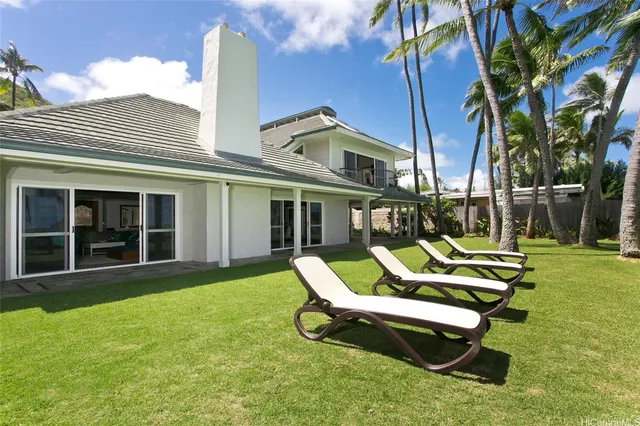 a view of a house with backyard porch and sitting area