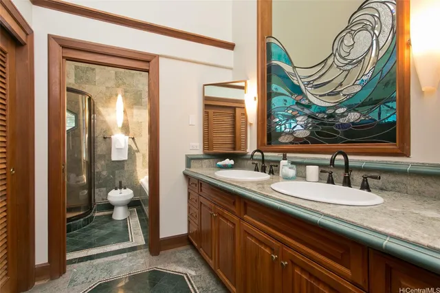 a bathroom with a granite countertop sink and a mirror