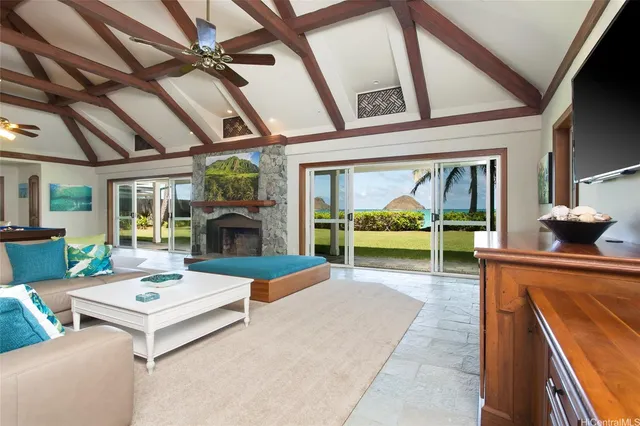 a living room with fireplace furniture and a large window