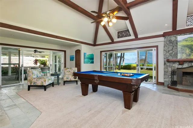 a living room with furniture a fireplace and a table
