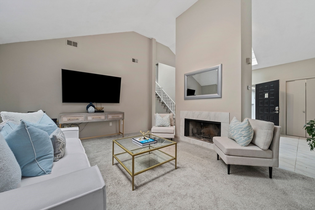 31 Dedham Street Sharon, MA 02067 - Photo 14 of 42 a living room with furniture a fireplace and a flat screen tv
