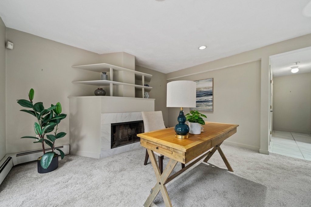 31 Dedham Street Sharon, MA 02067 - Photo 18 of 42 a living room with furniture a potted plant and a fireplace