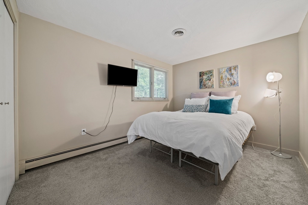 31 Dedham Street Sharon, MA 02067 - Photo 23 of 42 a bedroom with a bed and a flat screen tv