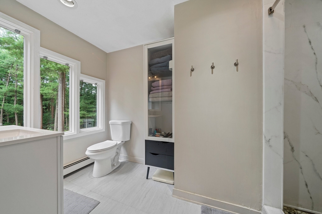 31 Dedham Street Sharon, MA 02067 - Photo 26 of 42 a bathroom with a toilet a sink and a window