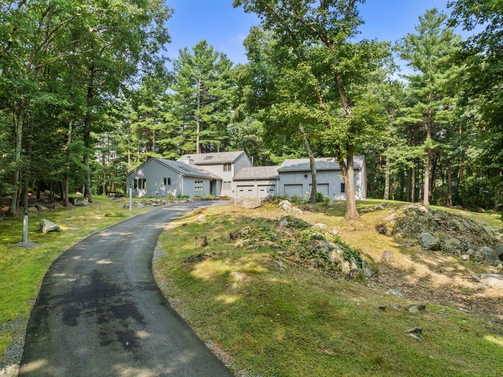 31 Dedham Street Sharon, MA 02067 - Photo 39 of 42 a view of a backyard with a small cabin