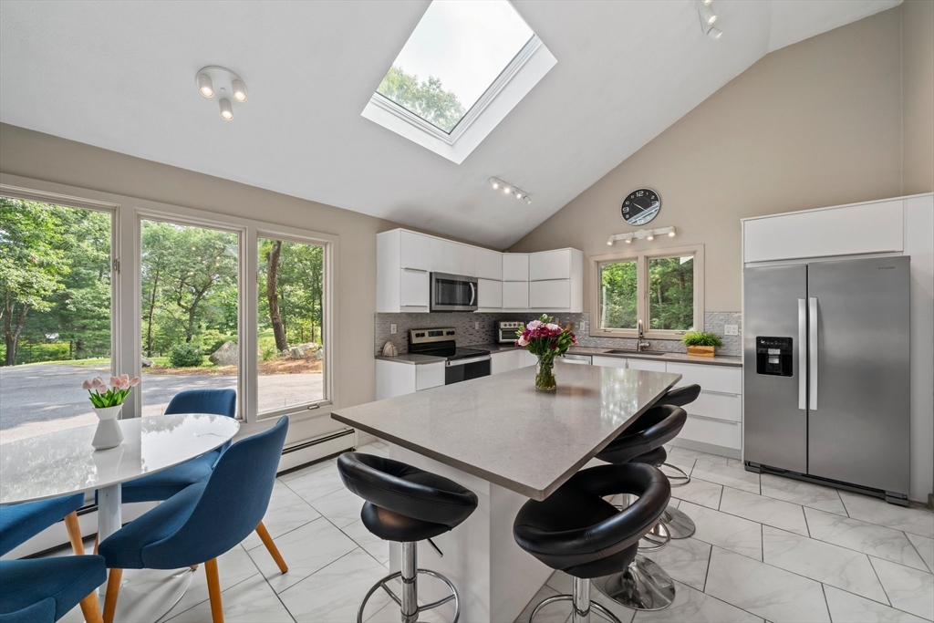 31 Dedham Street Sharon, MA 02067 - Photo 6 of 42 a kitchen with a dining table chairs and refrigerator