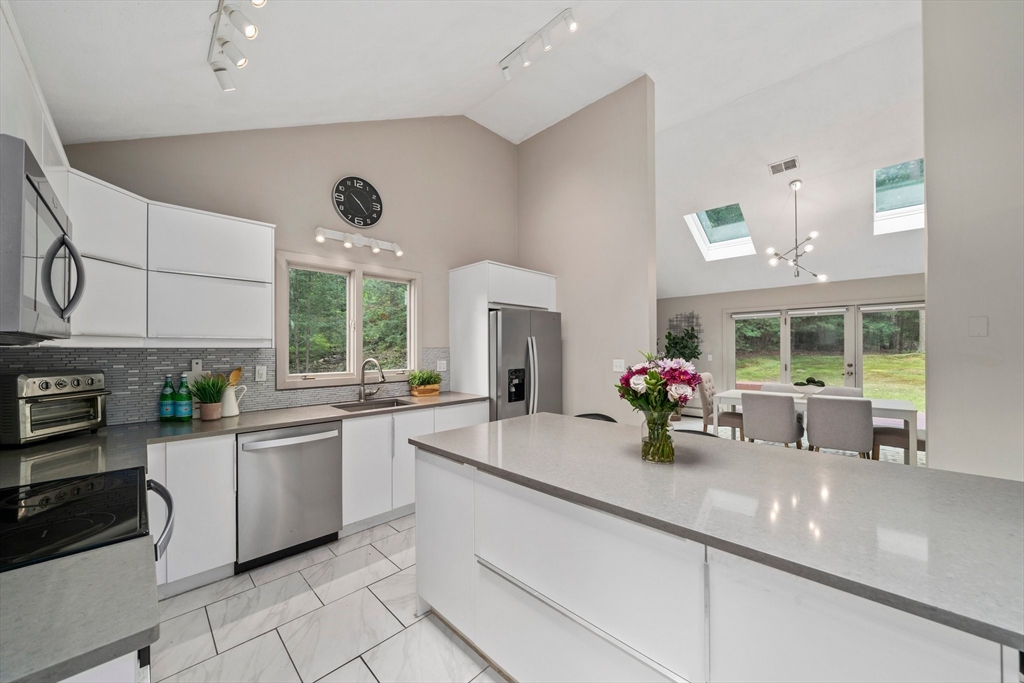 31 Dedham Street Sharon, MA 02067 - Photo 10 of 42 a kitchen with stainless steel appliances a sink and large window