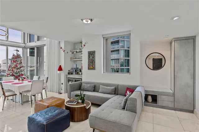 a living room with furniture and a floor to ceiling window