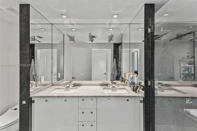 a bathroom with a shower sink double and mirror